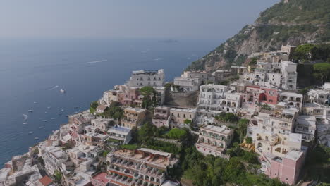 Wide-aerial-footage-rotating-around-on-the-hills-covered-in-houses-surrounding-the-town-of-Positano,-Italy-on-the-Amalfi-Coast