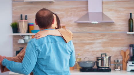 Charming-couple-dancing-in-kitchen
