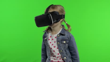 Child-girl-using-VR-app-helmet-to-play-simulation-game,-drawing.-Watching-virtual-reality-3d-video