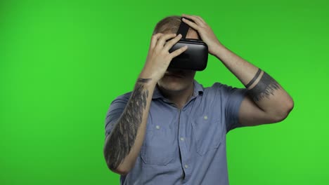 Man-using-VR-app-helmet-to-play-simulation-game,-drawing.-Guy-watching-virtual-reality-3d-video