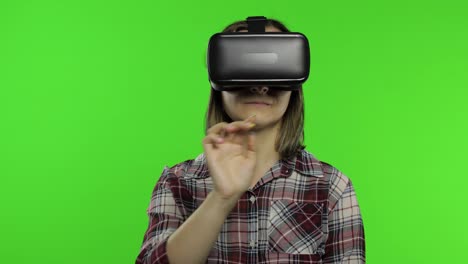 Woman-using-VR-headset-helmet-to-play-game.-Watching-virtual-reality-3d-360-video.-Presses-buttons