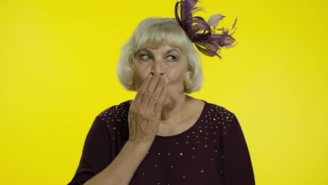 Shocked-frightened-senior-old-woman-covering-mouth-with-hand-and-looking-terrified-at-camera