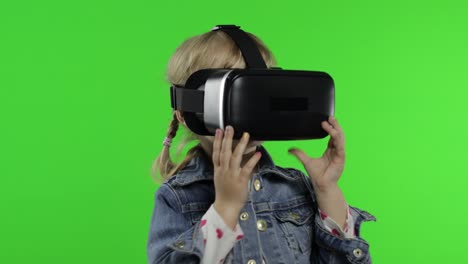 Child-girl-using-VR-app-helmet-to-play-simulation-game,-drawing.-Watching-virtual-reality-3d-video