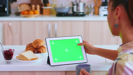 Tapping-on-tablet-computer-with-green-screen