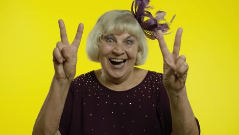 V-sign,-peace.-Happy-senior-old-woman-showing-victory-sign-with-double-fingers-and-smiling