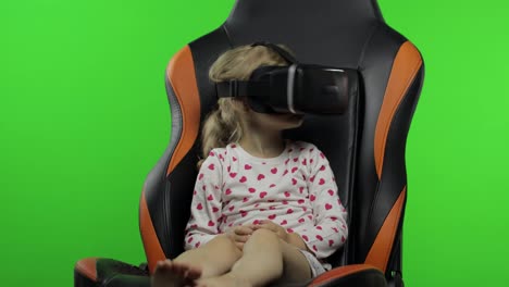Child-girl-using-VR-helmet-to-play-simulation-game-app.-Watch-virtual-reality-3d-video.-Chroma-key