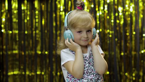 Child-dances,-listens-music-on-headphones.-Little-kid-girl-dancing,-having-hun,-relaxing,-enjoying