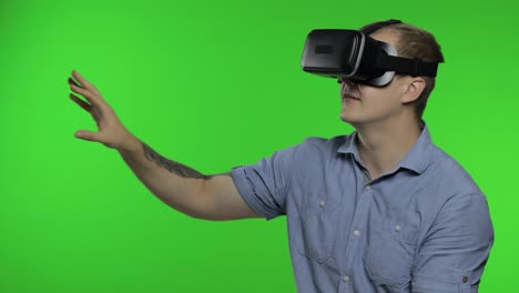 Man-using-VR-app-helmet-to-play-simulation-game,-drawing.-Guy-watching-virtual-reality-3d-video