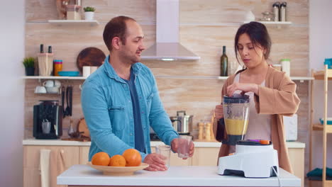 Woman-pouring-tasty-smoothie