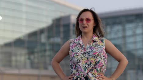 Angry-mad-woman-tourist-in-trendy-sunglasses-raising-fists,-looking-at-camera-with-furious-face