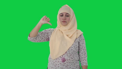 Disappointed-Muslim-teacher-showing-thumbs-down-Green-screen