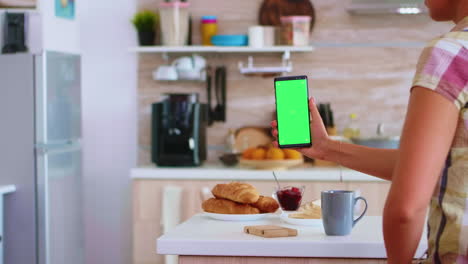 Holding-phone-with-green-touch-screen