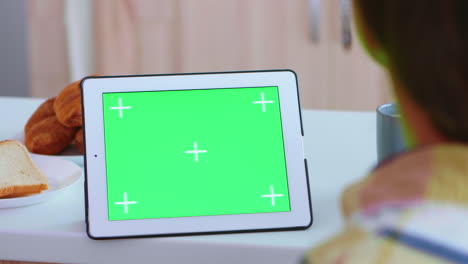 Watching-tablet-computer-with-green-screen