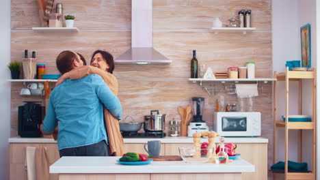 Tender-couple-dancing-in-kitchen