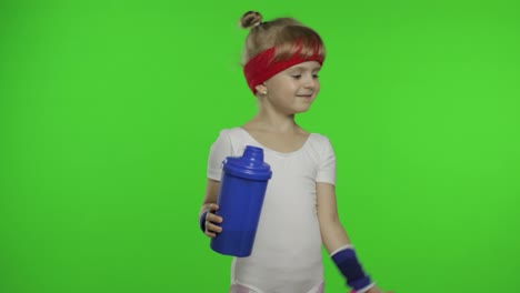 Girl-in-sportswear-making-fitness-exercises-with-dumbbells-and-drinking-water.-Little-athletic-child