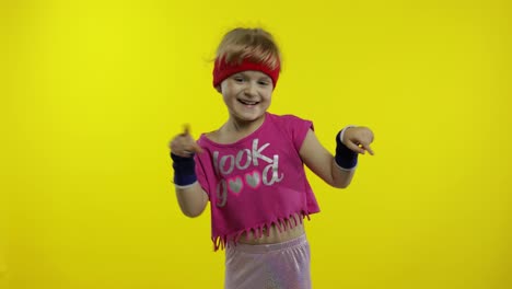 Little-energetic-caucasian-girl-in-pink-sportswear-making-fit-dance,-modern-aerobic-dancer
