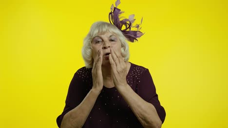 Happy-senior-old-woman-sending-air-fly-kisses-to-camera,-demonstrating-love,-romantic-emotions