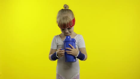 Girl-in-sportswear-drinking-water-for-refreshment-after-fitness-exercises.-Little-athletic-child