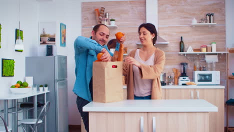 Guy-juggle-for-wife-in-kitchen