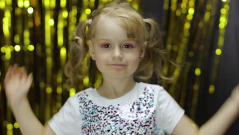 Child-dancing,-enjoying-music,-moving-in-dynamic-winning-dance.-Girl-4-5-years-old-in-shiny-t-shirt