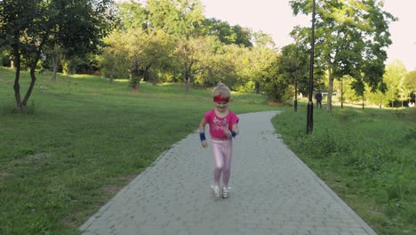 Little-caucasian-runner-child-girl-in-pink-sportswear-running-outdoors-in-park.-Workout-for-kids