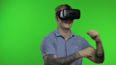 Man-using-VR-headset-helmet-to-play-game.-Watching-virtual-reality-3d-360-video.-Chroma-key