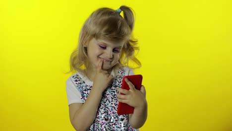 Child-girl-scrolling-social-network-posts-on-smartphone.-Remote-online-shopping,-browsing-on-phone.