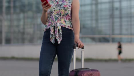 Girl-wearing-trendy-sunglasses-uses-her-phone.-Using-smartphone-for-call,-talk.-Vacations,-tourism