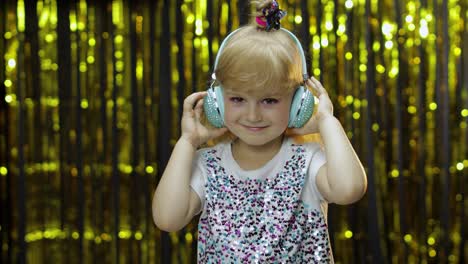Child-dances,-listens-music-on-headphones.-Little-kid-girl-dancing,-having-hun,-relaxing,-enjoying