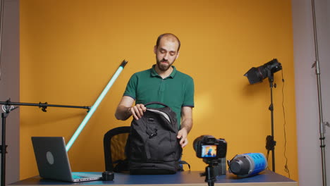 Protographer-presenting-gear-backpack