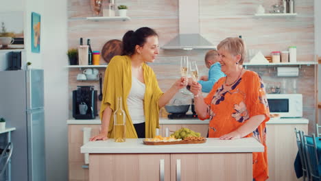 Mother-and-daughter-clinking-glasses-of-wine