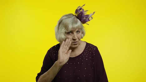 Senior-old-woman-showing-admonishing-finger-gesture,-disapproval-sign,-asking-to-stop.-Slow-motion