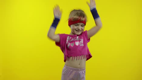 Little-energetic-caucasian-girl-in-pink-sportswear-making-fit-dance,-modern-aerobic-dancer