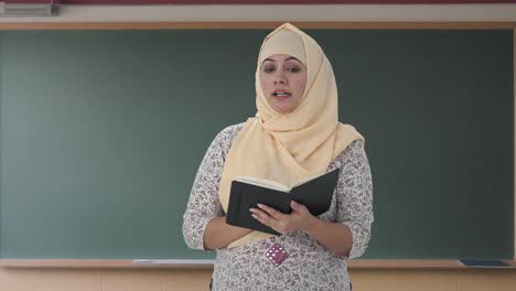 Muslim-teacher-teaching-in-school