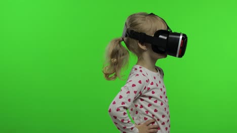 Child-girl-using-VR-helmet-to-play-simulation-game-app.-Watch-virtual-reality-3d-video.-Chroma-key