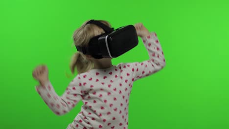 Child-girl-using-VR-headset-helmet-to-play-game.-Watching-virtual-reality-3d-360-video.-Dancing