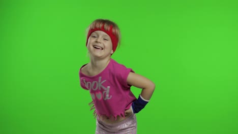 Little-girl-in-pink-sportswear-tells-something-and-showing-thumb-up-gesture.-Chroma-key-background