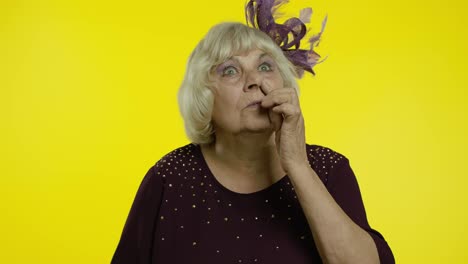 Funny-stupid-senior-old-woman-picking-nose-with-silly-expression,-removing-boogers,-bad-manners