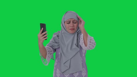 Angry-Muslim-woman-talking-on-video-call-Green-screen