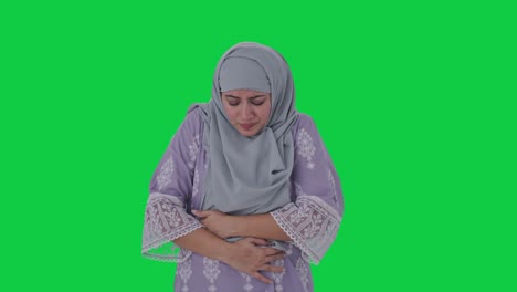 Muslim-woman-suffering-from-Stomach-pain-Green-screen