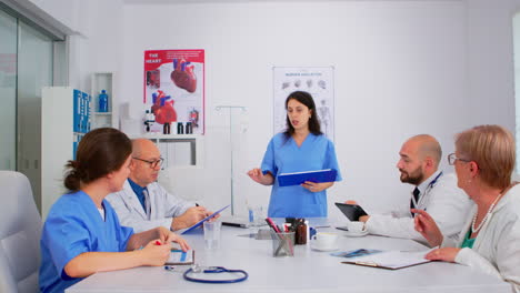 Attentive-medical-team-discussing-medicine-problems-using-tablet