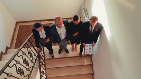 Top-view-of-business-colleagues-climbing-up-together-on-stairs