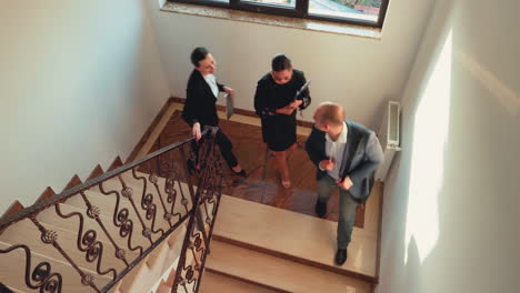 Top-view-of-business-colleagues-climbing-down-together-on-stairs