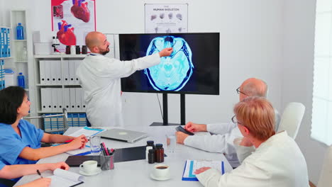 Doctor-making-presentation-to-medical-staff-in-hospital-radiology-area
