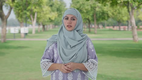 Muslim-woman-talking-at-the-camera-in-park