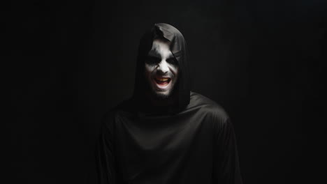 Grim-reaper-with-scary-laughing-over-black-background