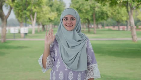 Glückliche-Muslimische-Frau,-Die-Im-Park-Hallo-Sagt