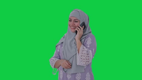 Happy-Muslim-woman-talking-on-phone-Green-screen