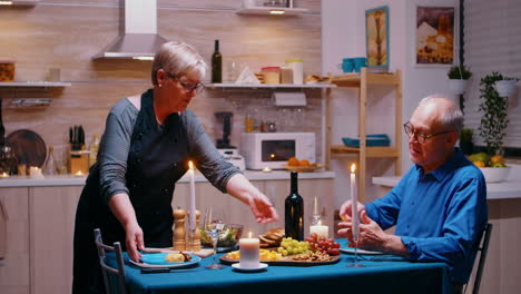 Senior-retired-woman-serving-dinner