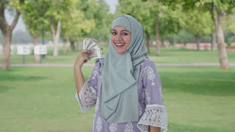 Glückliches-Muslimisches-Frauengeld-Als-Fan-Im-Park